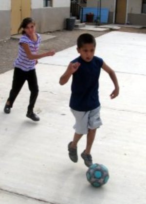 boy and girl playing soccer